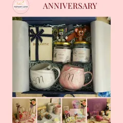 A closer look at one of my popular anniversary hampers. This one includes 'Mr & Mrs' mugs, premium perfumes, and cute Tom and Jerry figurines to represent a playful relationship, all packed in a classic blue box.