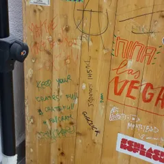 A close-up of the graffiti and stickers on the OG DJ booth. Every mark tells a story of an artist who passed through our studio.
