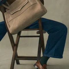 Our Penny Carryall in a beautiful neutral suede, paired with classic leather loafers. This bag was inspired by the iconic penny loafer, sharing its timeless appeal and everyday luxury.