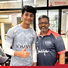 Weightlifter Shreeraj Bodke with his coach after winning a gold medal in the 69 kg category at the IEDSSA Zonal Weightlifting Competition.