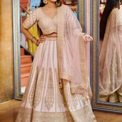This pastel pink lehenga with heavy golden embroidery is the definition of grace. It's a timeless piece, perfect for a bridesmaid or for attending a close family wedding.