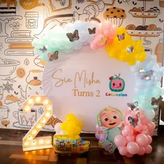 Two is terrific, especially with a Cocomelon theme. We set up this adorable backdrop with a balloon arch and character cutouts for Sia and Misha's second birthday celebration.