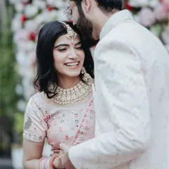 A close-up shot capturing a genuine, happy smile. The groom's tender gesture and the bride's joyful expression make this a perfect example of the candid moments I love to photograph.