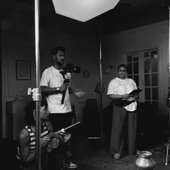 A moment of collaboration during a workshop. We work together to understand how light and shadow play, using tools like this large softbox to create a gentle, wrapping light that is perfect for soft portraits.