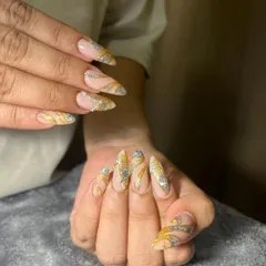 This bridal nail set is pure glamour. I used a combination of gold and silver glitter with swirling patterns over a neutral base to create a design that is both eye-catching and elegant for the big day.