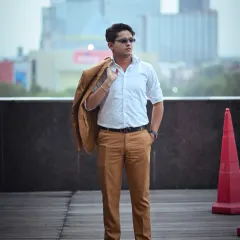 A relaxed yet stylish full-body shot with the jacket slung over the shoulder. This pose conveys a sense of ease and confidence, perfect for a more casual corporate or personal branding look.