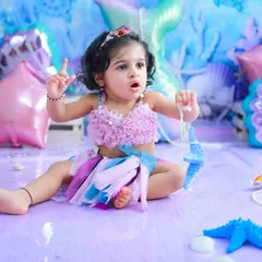 This little mermaid is pointing to the stars. I love capturing their curious gestures and expressions as they interact with the props in their magical underwater world.