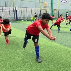 A player demonstrates flexibility and balance during our yoga session, a key part of our holistic athlete development.