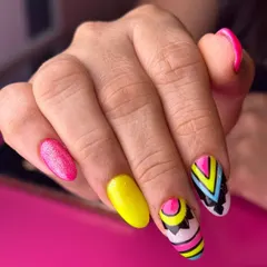 A vibrant and energetic pop art design. This set combines bright pink and yellow glitter nails with bold, geometric patterns for a look that is guaranteed to turn heads.