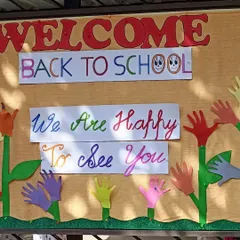 Another view of our welcoming bulletin board, decorated with children's handprint flowers.