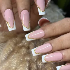 A futuristic take on the French manicure. This design uses long, squared-off extensions with a soft pink base and an abstract, liquid-gold chrome border for a bold and edgy look.