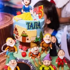 For little Tara's 5th birthday, we created this enchanting Snow White and the Seven Dwarfs cake. Each dwarf was hand-sculpted from fondant, and the top tier rotated to reveal different characters. It’s this attention to detail that makes our themed birthday cakes a magical experience for kids.