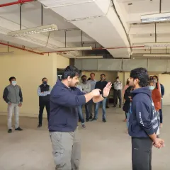 A typical corporate self-defense session in progress. I focus on teaching practical, defensive stances and blocks that can be used to create distance and de-escalate a threat in a professional or public environment.