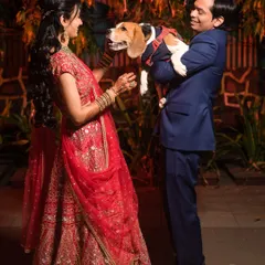 A family portrait with a furry twist. Arpita and Mahesh with their adorable beagle, because pets are family too.