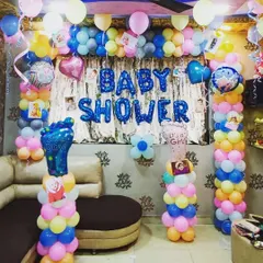 Another take on a baby shower decoration with pastel balloon pillars. This setup includes "It's a Boy" and "It's a Girl" foot-shaped foil balloons and can be personalized with baby photos.