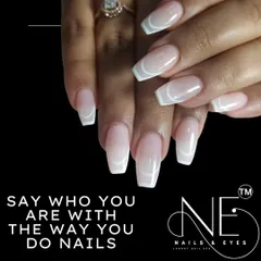 This is a minimalist and modern "outline" French manicure. We used clean white lines to trace the shape of the nail over a natural, glossy base on these coffin-shaped extensions.