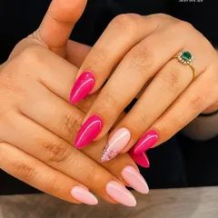 This manicure showcases a beautiful gradient of pinks, from a soft blush to a vibrant magenta. The almond shape is modern and elegant, with a touch of glitter on one nail for extra sparkle.