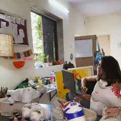 Here I am in my creative space, surrounded by paints, brushes, and a few works-in-progress. This is where I check emails and work on digital mockups for new projects.
