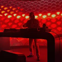 Setting the mood with dramatic red lighting. The right ambiance is key to building the energy for a great night of house and electro music.