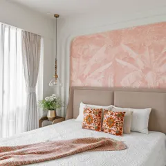 After: The completed bedroom, now a serene retreat with soft pink wallpaper, a custom-arched wall feature, and stylish pendant lights.
