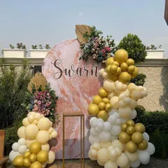 I also create personalized backdrops like this one for a client named Swarn. The marble-patterned board is decorated with beautiful balloon garlands and floral arrangements for a unique and elegant touch.