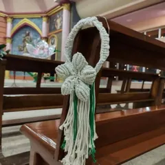 Another view of the single-flower pew hanger, showing how it adds a simple, elegant touch to the wedding decor.