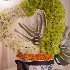 I love creating unique floral sculptures, like this heart-shaped arrangement crafted from green and white chrysanthemums. It's a modern and artistic way to express love or appreciation, presented in a decorative box.