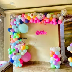 Personalization is key to making an event special. For this party, I arranged for a custom neon sign with the name 'Grisha' and designed a vibrant, multi-colored balloon garland to frame it, creating a unique and personal touch for the celebration.