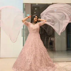 Feel like you're floating in a dream with this ethereal pink gown. The delicate embroidery and flowing fabric are perfect for a reception or engagement, ensuring you sparkle with every step and twirl.