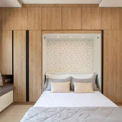 Here is the Murphy bed fully deployed, transforming the home office into a comfortable guest bedroom. The design includes integrated lighting and a decorative wallpapered niche for a cozy, finished look.