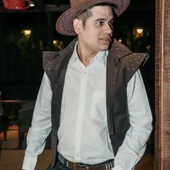 Dressed up in a cowboy costume for a themed event. I am always willing to go the extra mile and dress the part to enhance the event's theme.