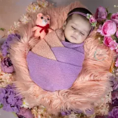 Wrapped in shades of lavender and peach, this little one is sleeping so soundly. I use a variety of soft wraps and props like this little teddy bear to add a touch of sweetness to each newborn portrait.