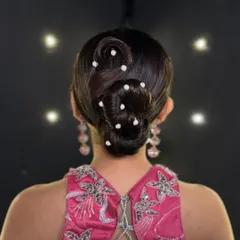A clear, direct shot of the finished S-wave bun. This view highlights the precise lines and smooth finish that define a professional updo, a key focus in my advanced styling lessons.