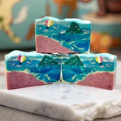 Capturing the energy of the ocean in a bar of soap. This beach-themed design features swirling waves, a pink sand shore, and even a tiny hot air balloon.