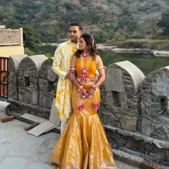 Coordinated couple sets are a popular choice for pre-wedding functions like a Haldi ceremony. For this couple, I designed a custom yellow printed kurta for him that perfectly matched the tone and style of her bespoke brocade skirt and embroidered blouse.