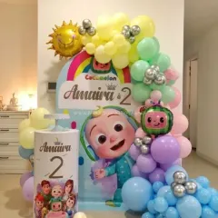 A personalized Cocomelon second birthday setup for Amaira. This compact yet detailed decoration includes a custom backdrop with the child's name, a pastel balloon arch, and character-themed elements.