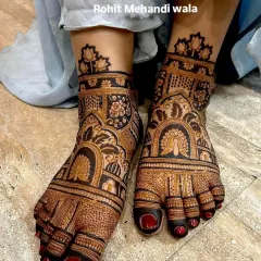 This design uses negative space to make the patterns stand out. The dark, filled-in areas highlight the peacock and floral motifs, creating a very bold and attractive look for the feet.