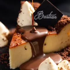 A moment of pure indulgence. For Bastian, we focused on capturing the decadent texture of their famous cheesecake, using a rich chocolate pour to create a dynamic and irresistible dessert photograph.