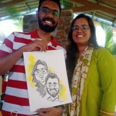 A happy couple showing off their caricature, drawn live at an event. I travel all over India to bring this unique form of entertainment to celebrations.