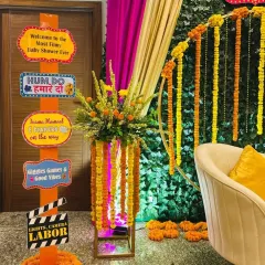Our custom-made signposts are a great way to add personality. This one, for a filmy-themed baby shower, uses Bollywood references and desi humor to create a fun photo opportunity for guests.