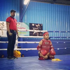 A moment of calm and respect before the fight begins. This young student is performing the Wai Kru Ram Muay, a traditional ritual in Muay Thai, at the national championship.