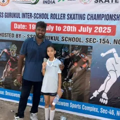 Celebrating an individual victory. One of our dedicated skaters proudly displays her silver medal next to the official banner of the SS Gurukul Inter-School Roller Skating Championship.