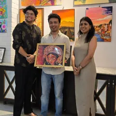 Curator Sarthak stands with the artist and new owner of the sold Durga artwork, marking another successful sale from the "Vernissage" show.