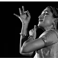 A black and white photograph capturing a moment of expression. The hands, the face, and the posture all work together to tell a story without words.