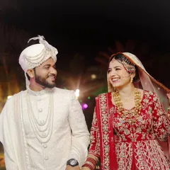 The happy couple, Qasim and Zubiya, sharing a smile after their wedding. This candid shot is full of warmth and joy.