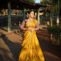 For a beautiful traditional look, I offer authentic South Indian half-sarees, also known as Langa Voni. This vibrant yellow silk piece is perfect for cultural functions or a unique pre-wedding photoshoot, and includes all the traditional temple jewellery you see here.