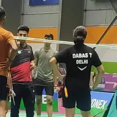 On-court strategy discussion with a player during a national tournament. In high-stakes matches, quick tactical advice from the sidelines can make all the difference.
