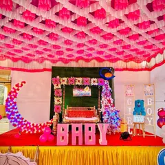 For a traditional Maharashtrian baby shower, or Dohale Jevan, I created this beautiful stage setup. It features a decorated jhula (swing), a large floral moon prop, and character cutouts of Radha and Krishna, all under a vibrant pandal ceiling.