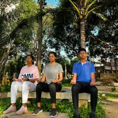 Students practicing meditation outdoors. We use these sessions to teach the importance of mental peace and focus, skills that are valuable both in shooting and in life.