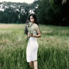 A creative shot using motion blur to create a dreamy, ethereal effect as the model walks through the field.